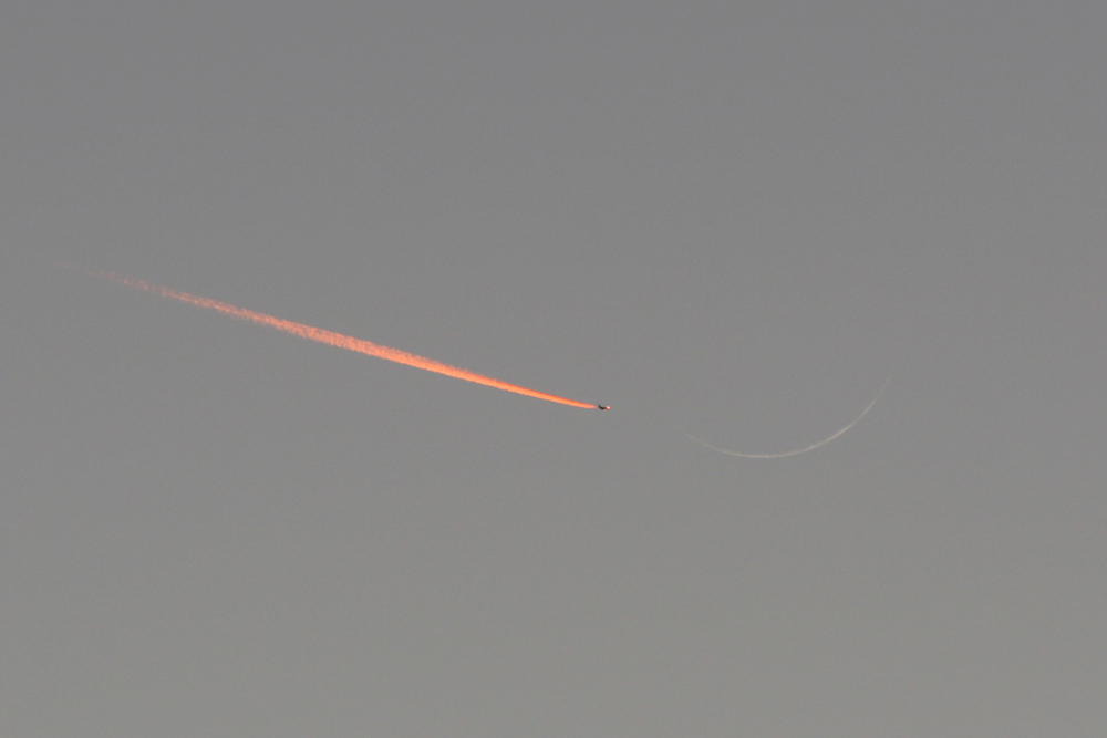 Jet Approaching a Crescent Moon